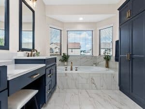 luxury master bathroom with blue cabinets and quartz