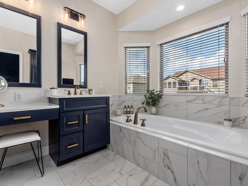 luxury master bathroom with blue cabinets and quartz