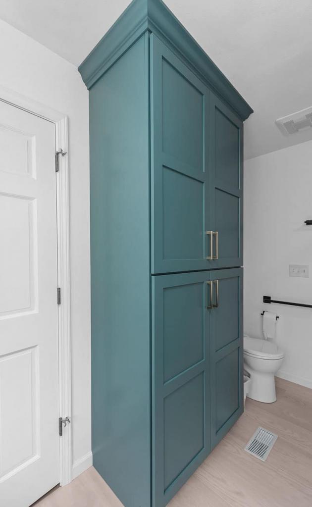 modern bathroom with green cabinets and white quartz counters