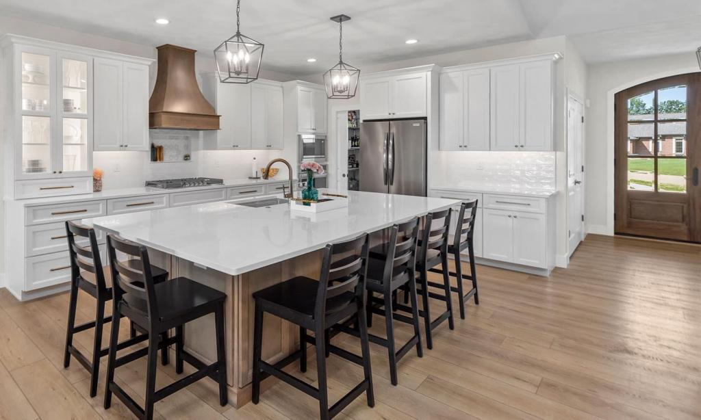 modern white kitchen with a copper stove hood