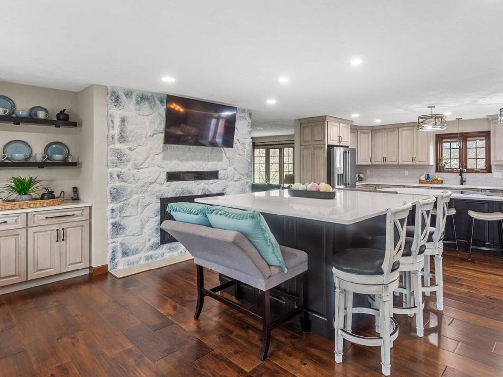 A modern, luxury kitchen with cream colored cabinets for the upper cabinet and lower cabinets are a dark maple