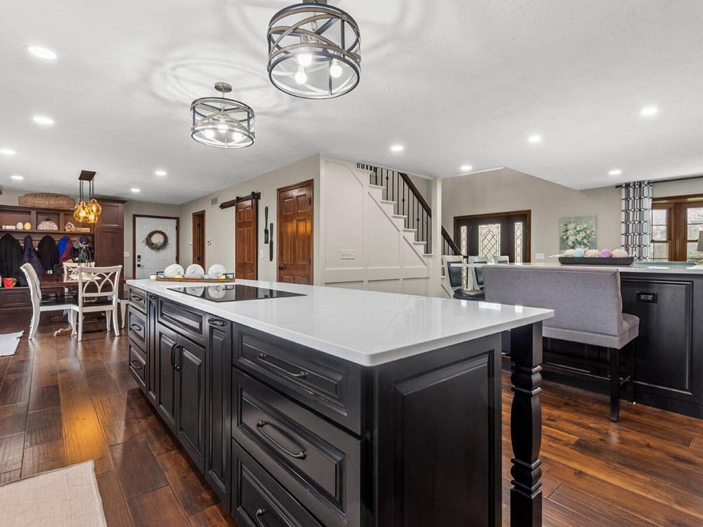 A modern, luxury kitchen with cream colored cabinets for the upper cabinet and lower cabinets are a dark maple