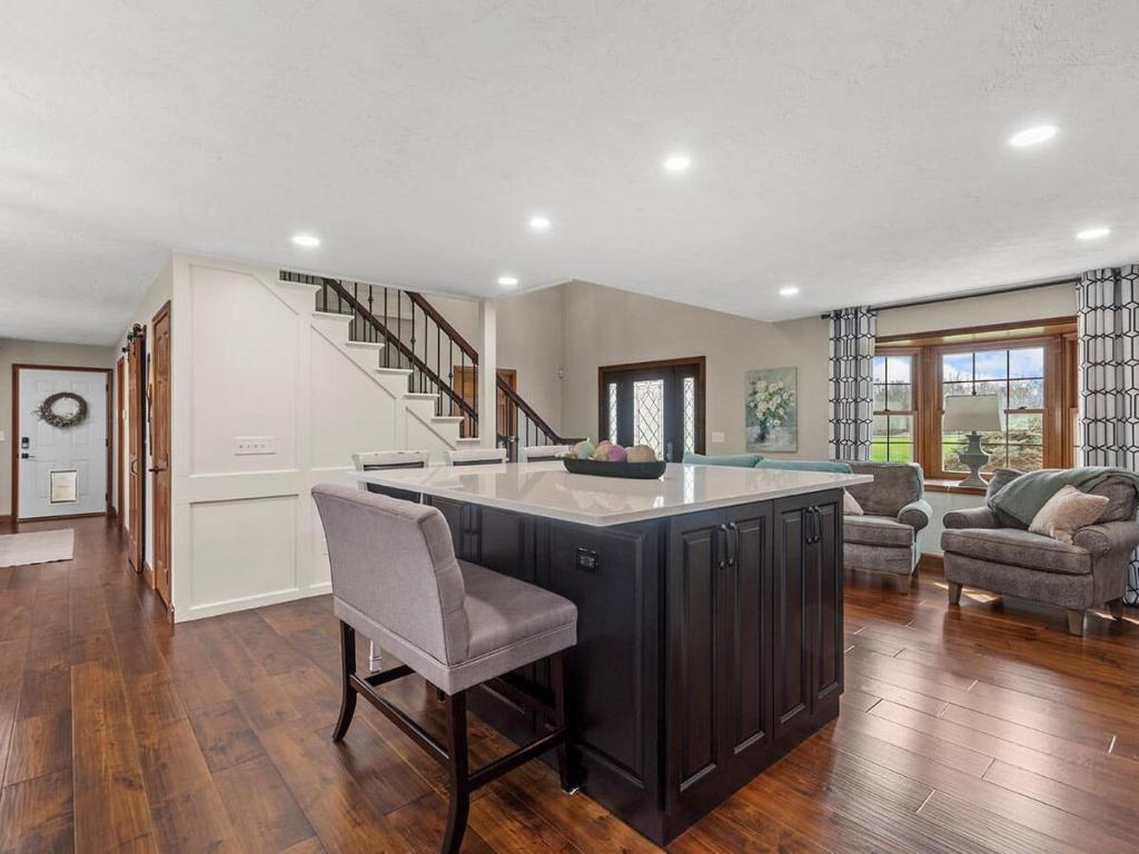 A modern, luxury kitchen with cream colored cabinets for the upper cabinet and lower cabinets are a dark maple