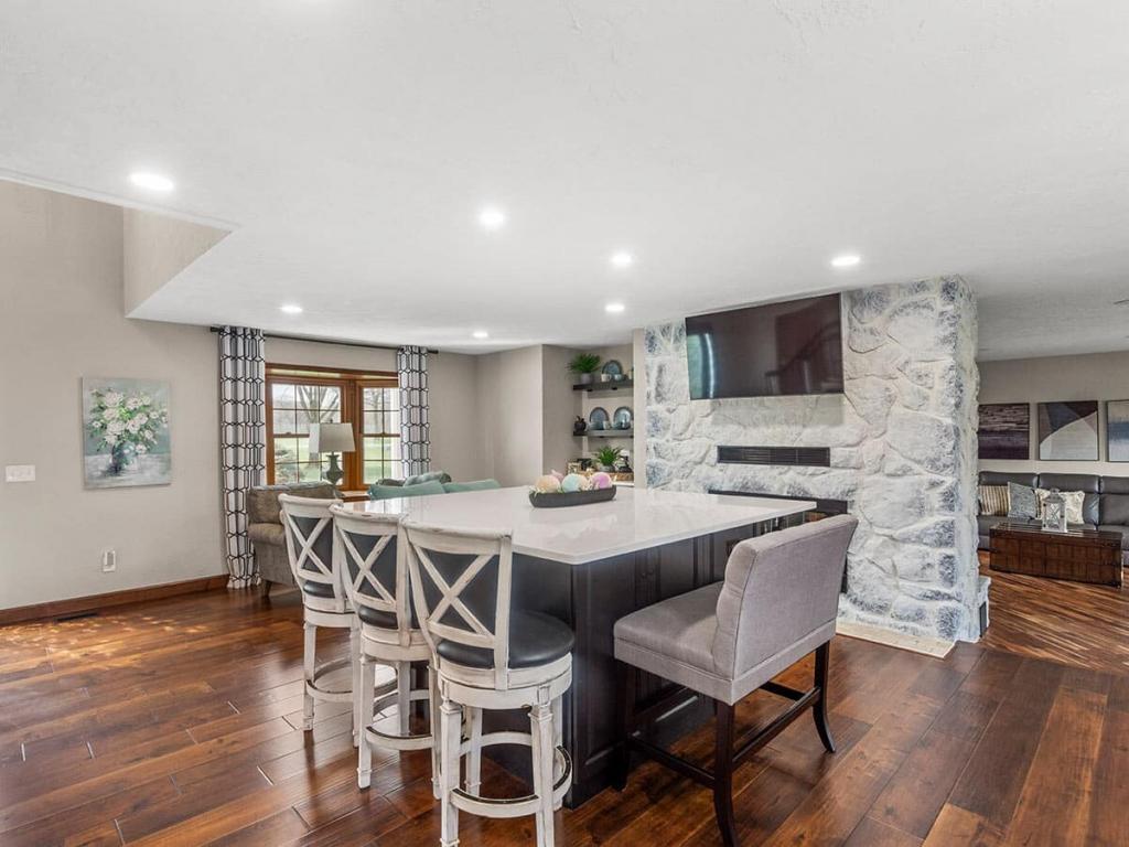 A modern, luxury kitchen with cream colored cabinets for the upper cabinet and lower cabinets are a dark maple