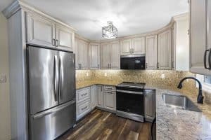 beautiful kitchen remodel with cream cabinets and stunning quartz